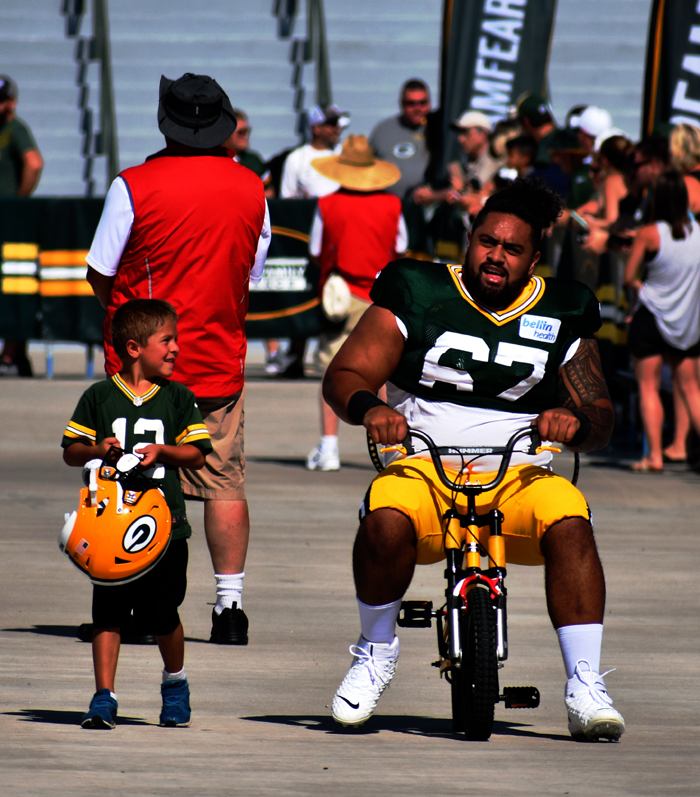 Guard Larry Williams is a little too big for this youngster's bike.