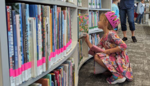 A child picking out a library book