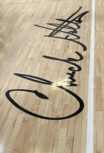 Chuck Holton's signature enscribed on a baseball court