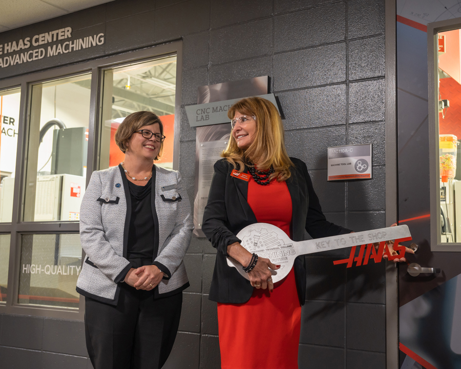 NWTC President Dr. Kristen Raney, at left, looks on as Kathy Looman director of education grants, Gene Haas Foundation, unlocks the shop of the Gene Haas Center for Advanced Machining at NWTC.
