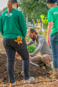 Joshua Kufahf, center, demonstrates seed planting techniques to volunteers. Shane Fitzsimmons photo