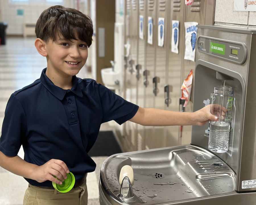 Photo of a middle schooler filling a water bottle