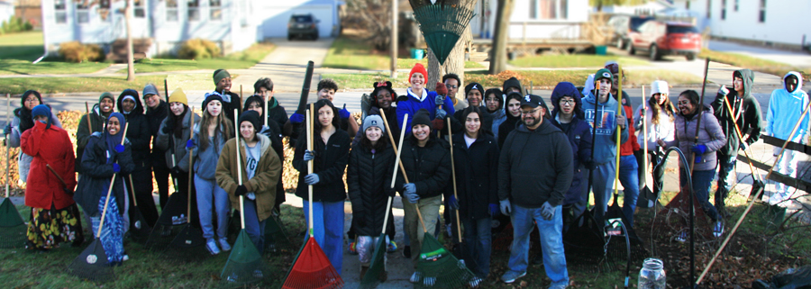 Green Bay East high school students pose while raking the yards of nearby houses in 2022. William Garay photo