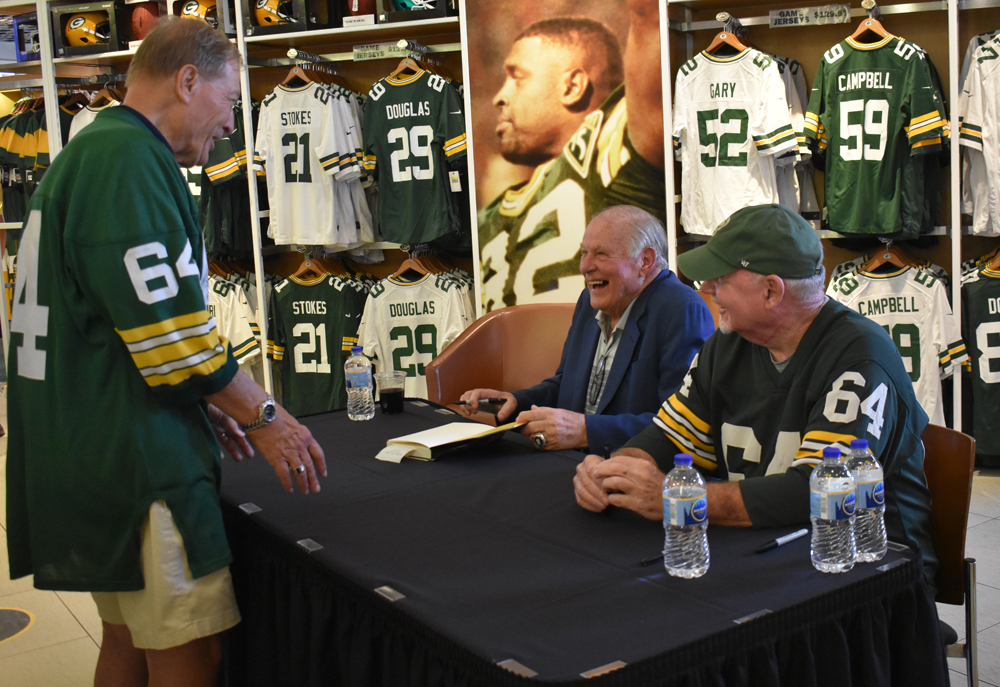 Jerry Kramer and Bob Fox laugh with a fan