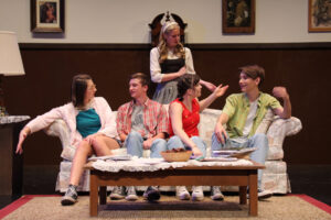 5 students on stage acting in a play