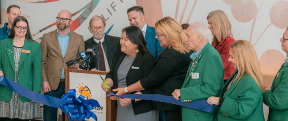 Golden House Executive Director Cheeia Lo, center, cuts the ribbon on the new and expanded facility.