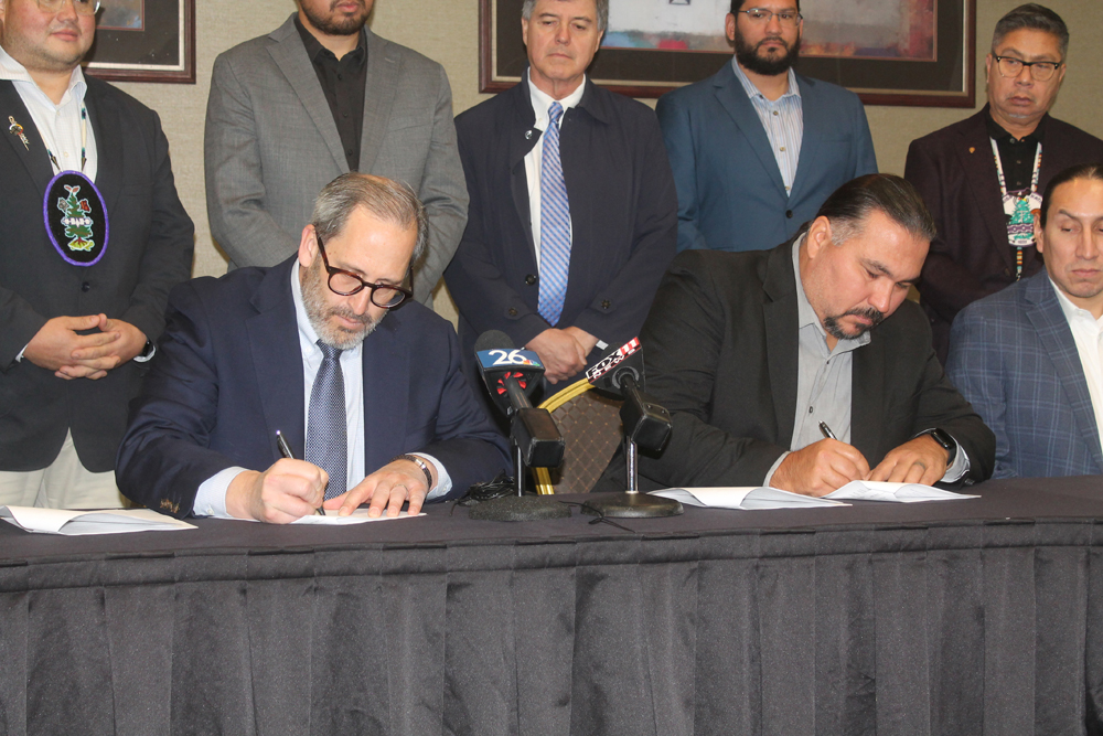Brown County Executive Troy Streckenback, at left, and Oneida Nation Chairman Tehassi Hill sign the intergovernmental agreement on Nov. 1 at the Radisson Hotel and Conference Center. The agreement went into effect that day and runs until Oct. 31, 2038. Kris Leonhardt photo