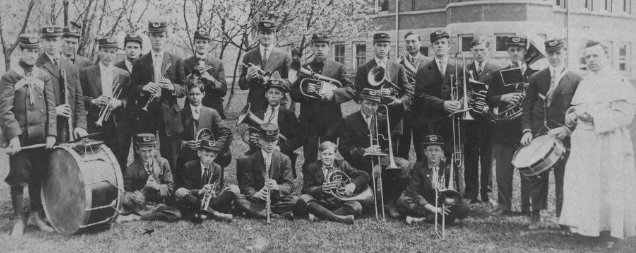 The 1910-11 St. Norbert College band, under the direction of director, Father Raphael Gerard Geven, poses next to Main Hall. St. Nobert College photo
