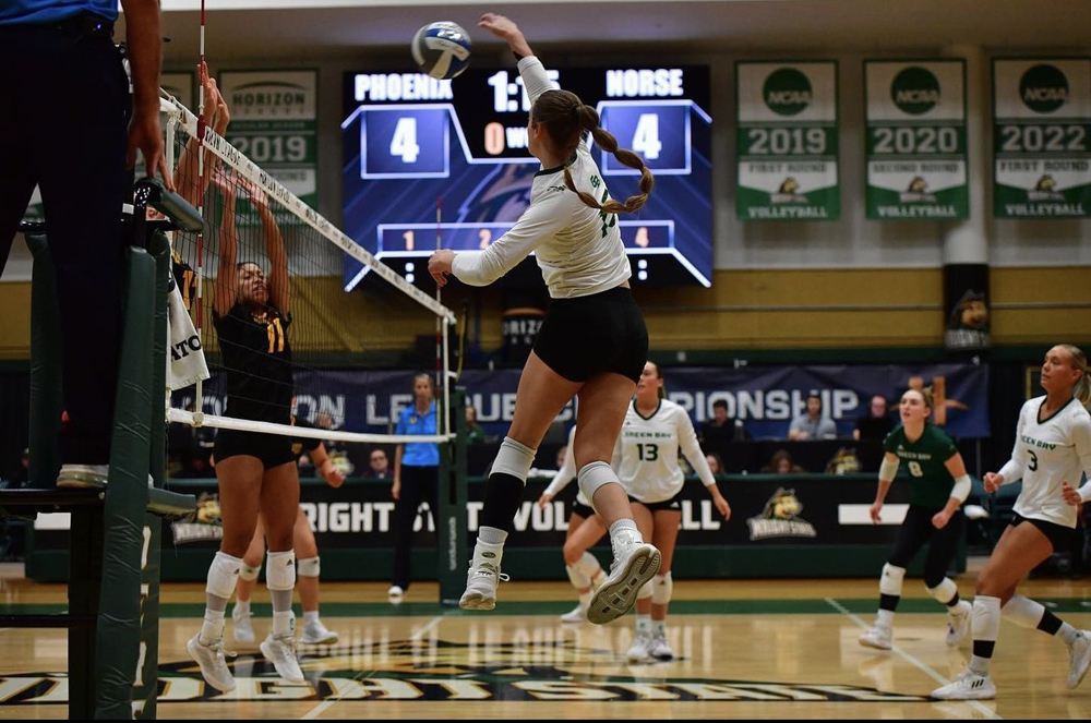 Green Bay Phoenix Cora Behnke leaps up to hit the ball in the Phoenix's game against Northern Kentucky University to propell them on to the Horizon League Championship. Green Bay Athletics photo