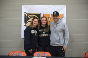 Kibbe stands with her parents on one of the biggest days of her athletic career.