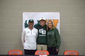 Haup stands with his parents after officially commiting to play golf at UW- Green Bay.