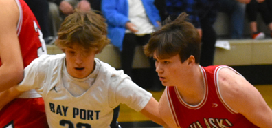 Pulaski's Bryce Wotruba is closely guarded by Bay Port's Caden Hendricks during first-half action on Dec. 19. The Pirates won the FRCC contest, 75-72. Rich Palzewic photo