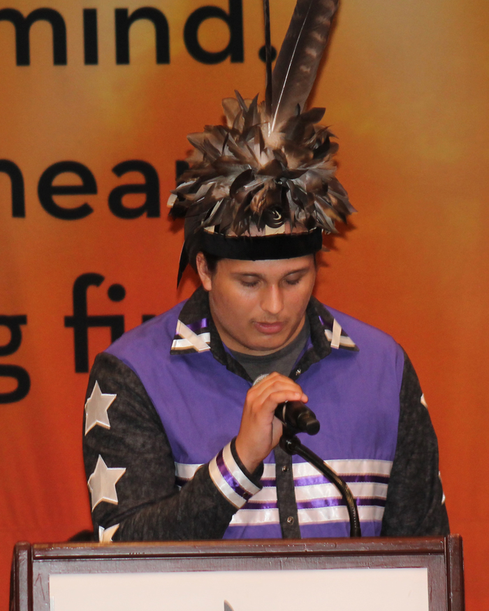 A Native person speaking at a podium