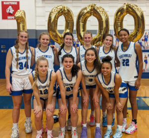 Pytleski, third from right in top row, poses with her team after their victory to celebrate her accomplishment of scoring 1,000 career points.