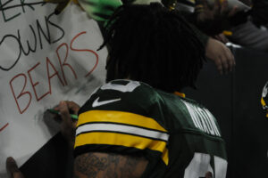 Green Bay Packers Cornerback Keisean Nixon stops to sign a fan's banner during the 2023 season
