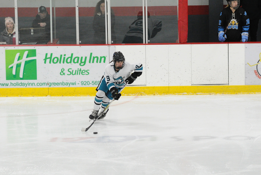 Ice Bear Emily Bill takes the puck down the rink in their game against the Wisconsin Valley Union