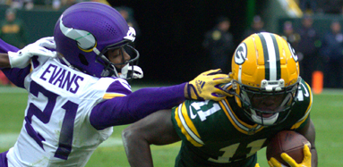 Green Bay Packers Wide Reciever Jayden Reed dodges an attempt from Vikings Cornerback Akayleb Evans in their last game on Oct. 29 at Lambeau Field