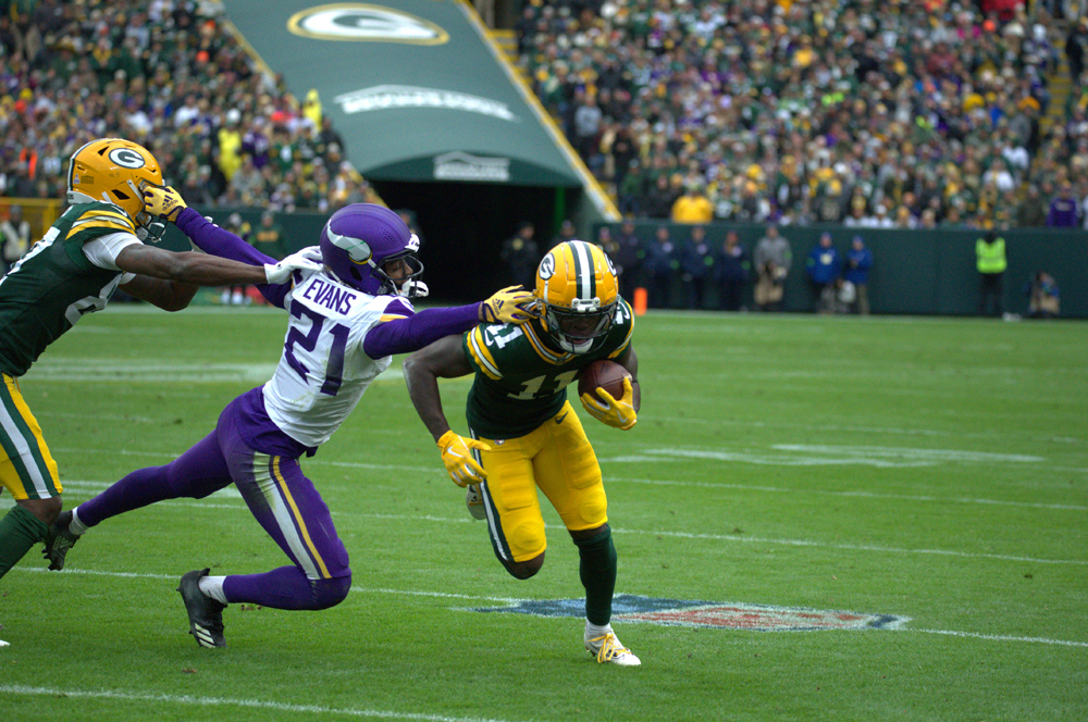 Green Bay Packers Wide Reciever Jayden Reed dodges an attempt from Vikings Cornerback Akayleb Evans in their last game on Oct. 29 at Lambeau Field