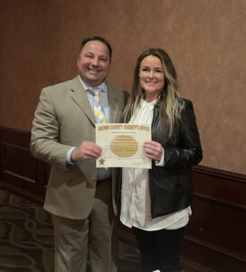 Brown County Sheriff Todd Delain presents Christa Chervenka with a Good Samaritan award