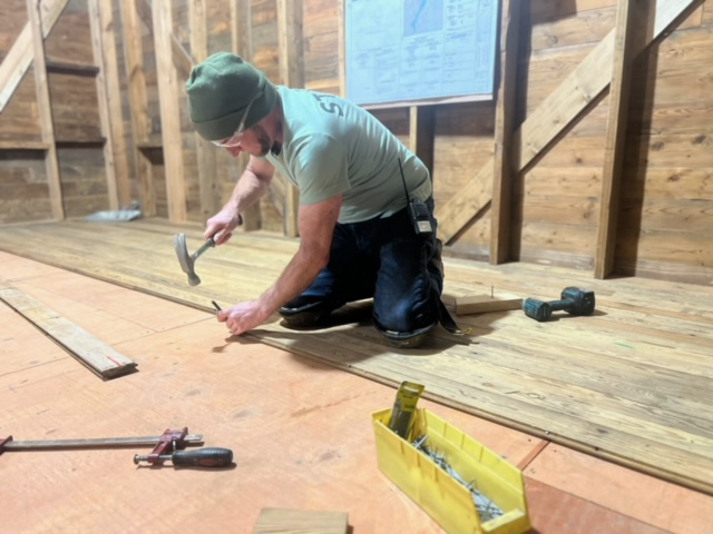 David Haack installs the orginal flooring.
