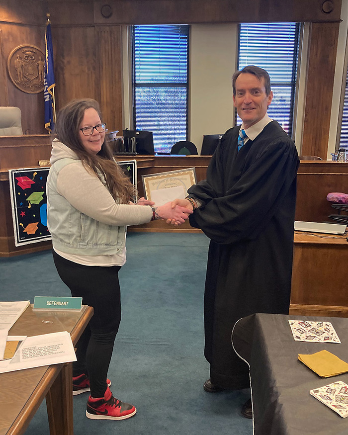 Trina Meyers, left, receives her diploma from  Brown County Circuit Court Judge Walsh after successfully completing heroin court in the Brown County Alternative Court.