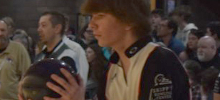 A male high schooler bowling