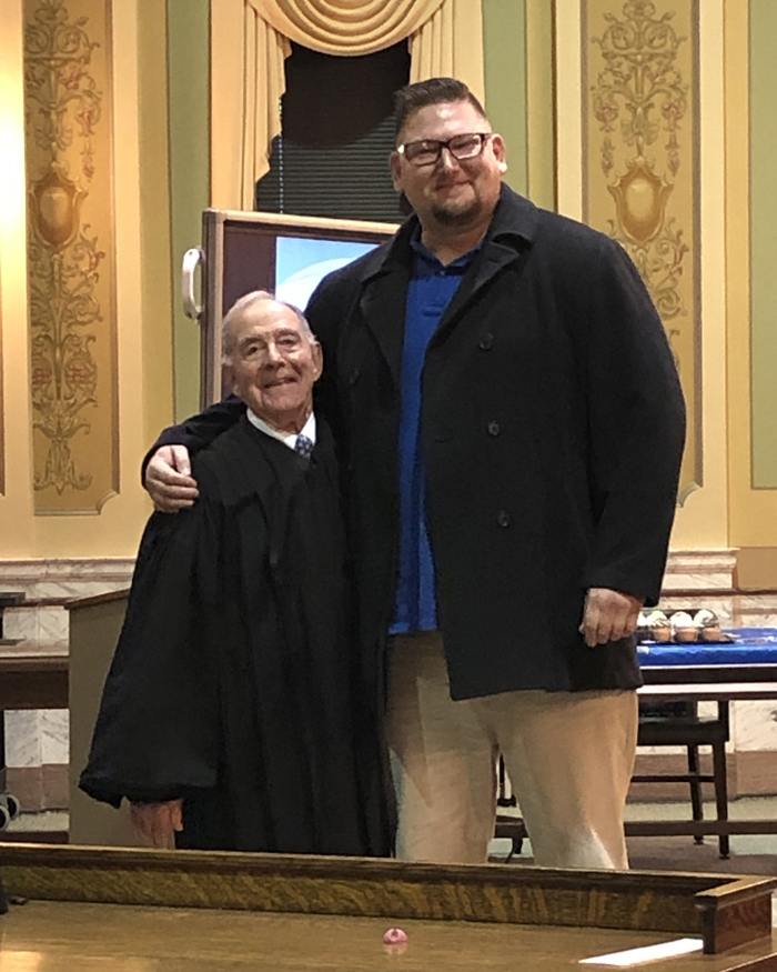 Nathan St. John receives his Mentah Health Alternative Court certificate from Brown County Chief Circuit Court Judge Donald Zuidmulder