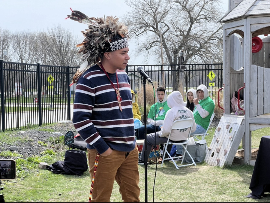 James Flores opened the story of the Peace Tree by speaking in Onyota’a:ká, the native language of the Oneida Nation, while the Menominee Indian High School Skud Nation Drum Group played
