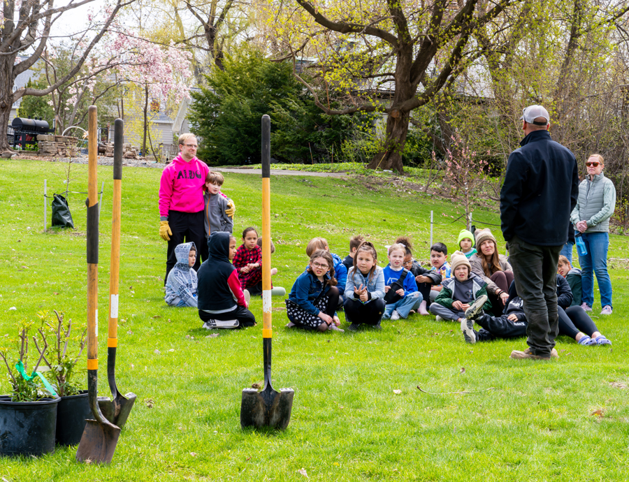 Josh Schmitt, a Brown County Parks Department field manager, goes over the plan to plant elderberry shrubs with first- and second- grade students from Aldo Leopold Community School at the Fox River Trailhead in Green Bay on Arbor Day